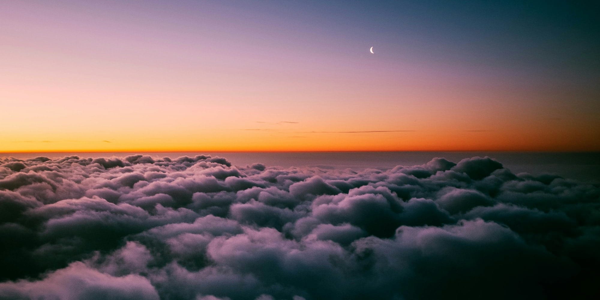 the sun is setting over the clouds in the sky